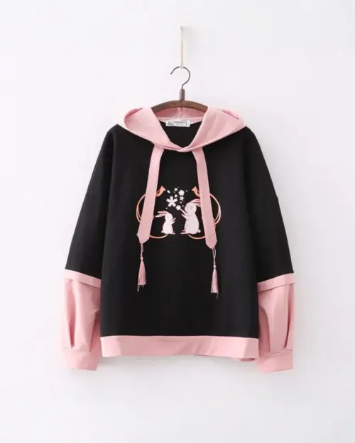Black sakura bunny hoodie with pink sleeves, featuring embroidered bunnies and tassels.