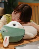 Close-up of a kawaii bunny plushie, Cotton the Adventurous Rabbit, resting on a wooden surface.