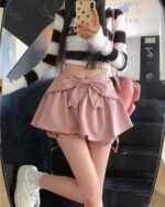 Pink Bow Petit Skirt - Coquette aesthetic skirt, worn with a striped sweater and sneakers.