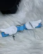 Blue kawaii leg accessory featuring white wings, a heart charm, and crosses.