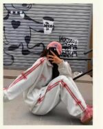 A person wearing a korean aesthetic set, including a sweater and pants, outdoors.