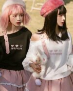 Two models wearing lolita aesthetic sweater with heart print and off-shoulder design.