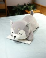 Shiba and husky plushie lying on a laptop, cutecore aesthetic.