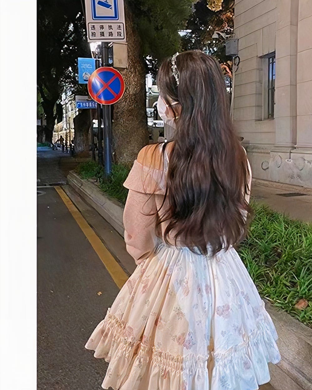 Soft girl dress featuring floral details and ruffles, worn by a person.