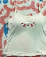 White cutecore aesthetic vest with cat face design.