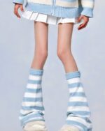 Close-up of striped gyaru socks, featuring a blue and white striped design worn with a skirt and cardigan.
