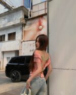 Woman wearing a korean off-shoulder top with a backless design.