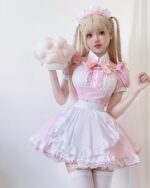 A person wearing a pink maid costume with a matching headband and thigh-high socks, featuring a kawaii aesthetic.
