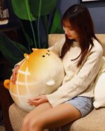 A kawaii melonwan dog plushie is held by a woman in a cozy setting.