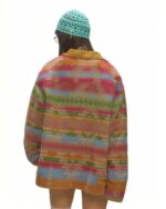 Back view of a vintage aesthetic jacket featuring a colorful woven design.
