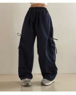 Dark blue Korean aesthetic pants, loose-fitting with drawstring details.