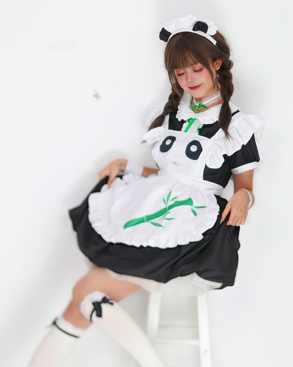 Panda maid costume featuring a girl in a black and white outfit with panda ears and a frilly apron.
