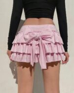 Pink ruffled coquette aesthetic skirt with bow tie closure.