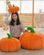 Large orange pumpkin plush cushion, decorative room decor with soft texture.