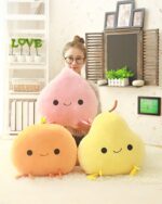 Two kawaii fruit plushies: a pink peach and a yellow chick, displayed with a girl.