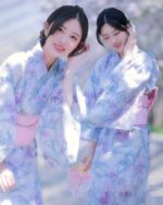 A woman wearing a pastel japanese yukata with floral print and fan, showcasing Japanese aesthetic.