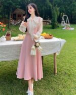 Long pink dress with lace sleeves, showcasing a vintage aesthetic dress in an outdoor setting.