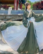 Jade Ruqun Hanfu Long Dress worn by a woman outdoors, featuring a flowing white skirt and green sleeves.