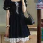 Black puffy dress with lace trim, a dark kawaii dress style.