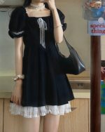 Black puffy dress with lace trim, a dark kawaii dress style.