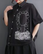 Black retro aesthetic shirt with floral and geometric embroidery details.