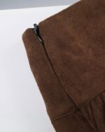 Close-up of an aesthetic vintage skirt, brown suede material with a zipper.