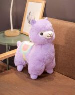 A plush, colorful alpaca plush - Andean Edition, resting on a couch.
