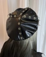 Black studded punk beret made from vegan leather, featuring multiple eyelets and spikes.