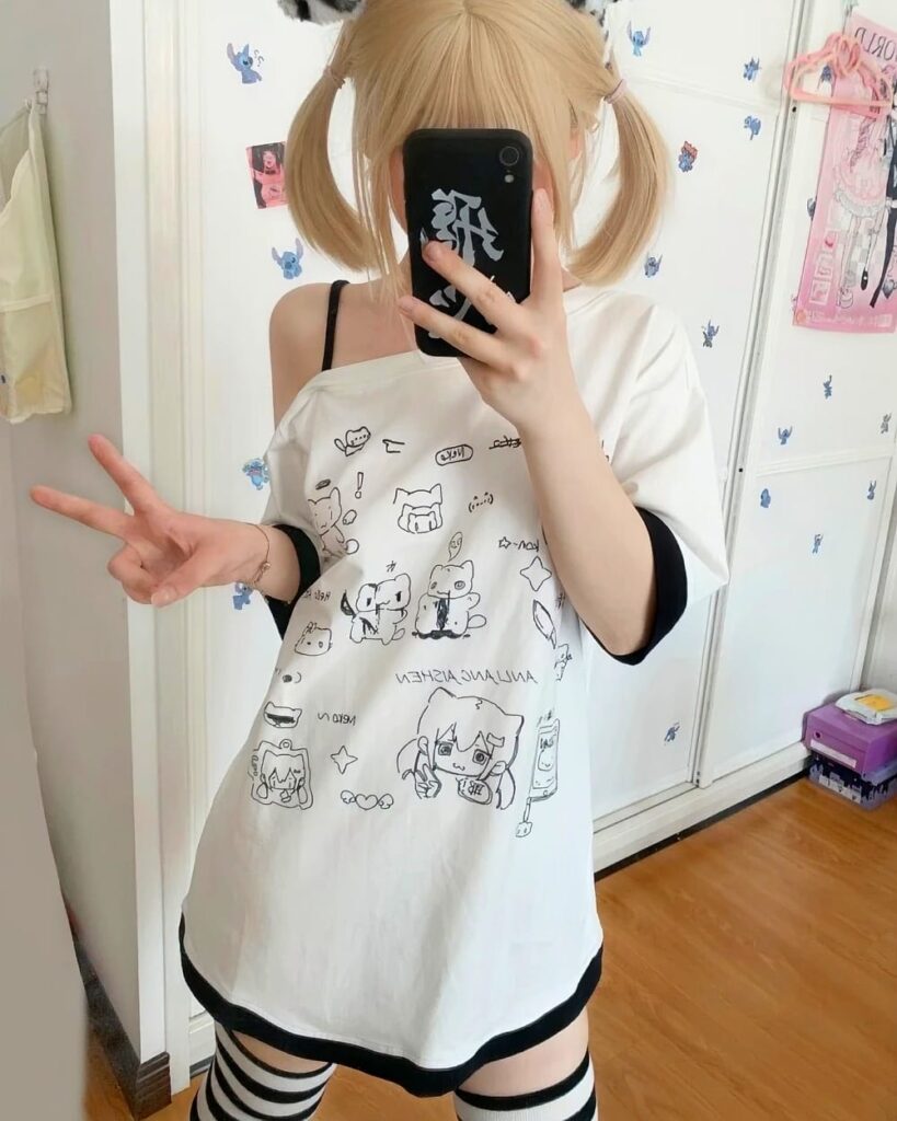 White harajuku kawaii t-shirt with cute character prints, layered over a black shirt.