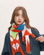 Woman wearing a colorful fox scarf with a cottage aesthetic design.