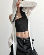 Silver hooded cut out top with a gothic aesthetic, featuring a cutout design and draped fabric.