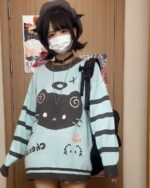 Mint neko sweater, striped knitwear featuring a black cat graphic, Harajuku style.