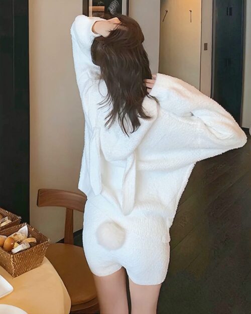 Woman wearing fluffy bunny pajamas, soft girl aesthetic white loungewear.