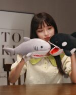 Kawaii animal puppets featuring a gray plush shark puppet held by a person.