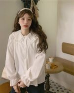 White vintage aesthetic shirt with a frilled collar and puff sleeves, coquette fashion style.