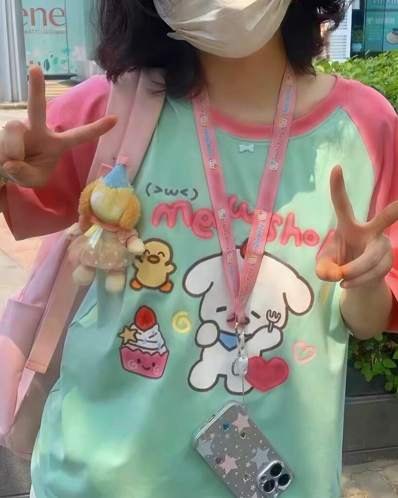 A light green lolita aesthetic tee featuring cute cartoon dogs and pink accessories.