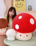 Set of giant mushroom plushies, including a large red one and smaller brown plushies. Chonky plush toy.