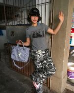 Woman wearing a gray retro grunge t-shirt with a graphic print.