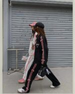 Woman wearing a korean aesthetic set including a sweatshirt, pants, and hat.