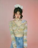 Model wearing a beige hollow-out knitted long-sleeved vintage aesthetic sweater.