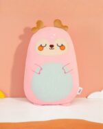 Kawaii bean-shaped wild animal plushie featuring a pink deer with orange details and a teal belly.
