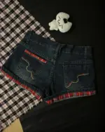 Two kawaii denim shorts with red flannel lining, Y2K aesthetic style.