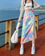 Denim y2k skirt with colorful tie-dye pattern and side ties.