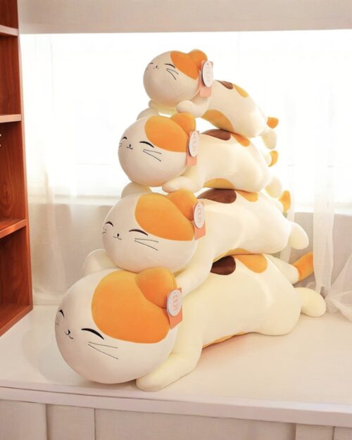 Stack of kawaii cat plushies, soft and cuddly, featuring brown and white markings.