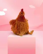 A brown fat chicken plushie sits on a white cube against a pink background.