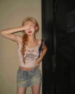 Model wearing The KItty Top - Y2k aesthetic top, a floral print crop top with spaghetti straps.