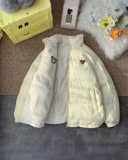 Light-colored bear heart jacket, featuring a plush sherpa lining and a decorative heart patch. A cute bear heart jacket.