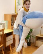 Blue kawaii whale plushie, soft and cuddly, features a smiling face.