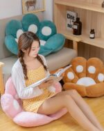 Kawaii Neko Paw Cushion set with a teal paw and pink cushion, displayed in a room setting.