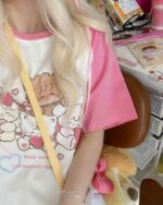 Close-up of a pink harajuku aesthetic t-shirt featuring a cartoon sheep design.